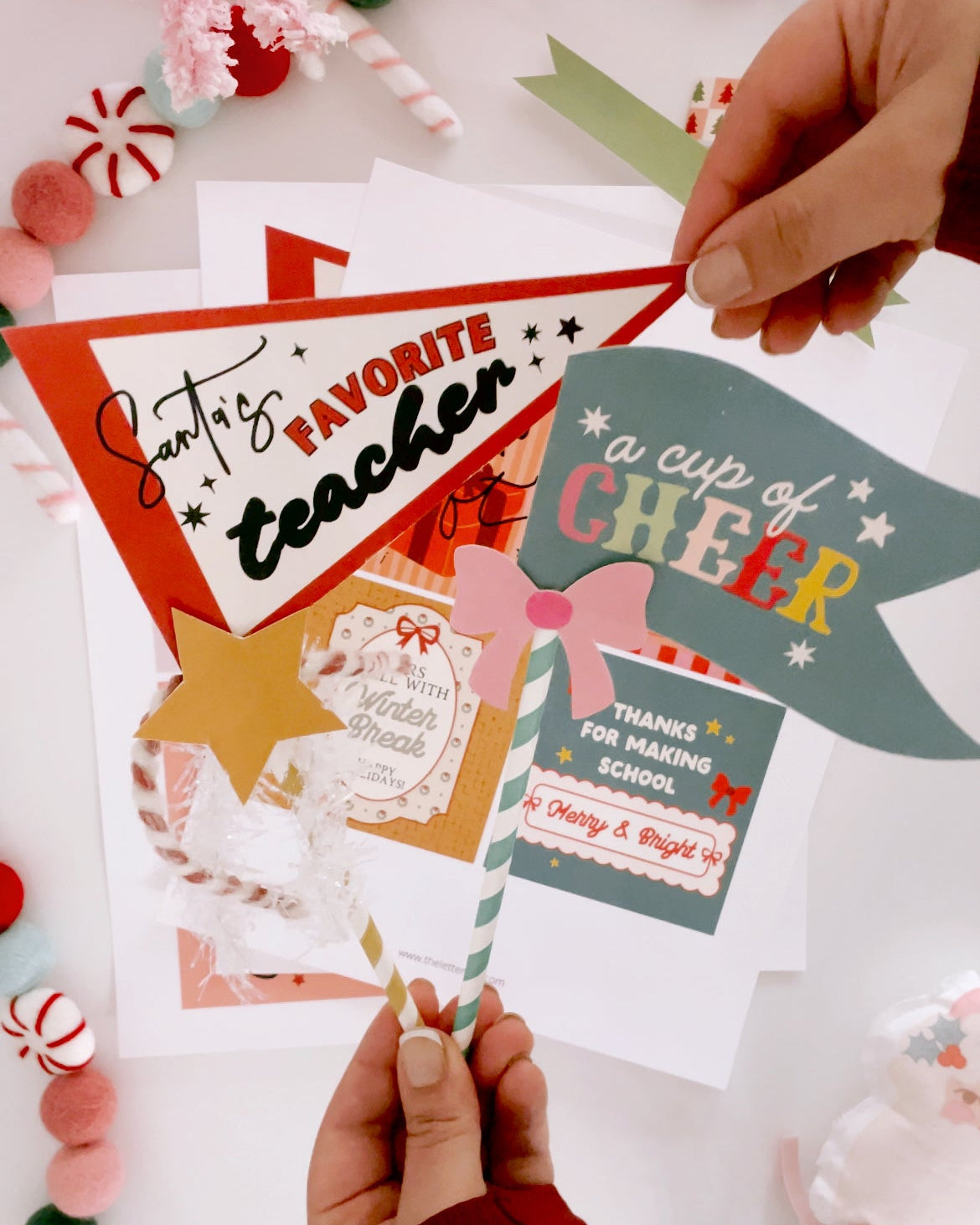 Colorful cards with text and graphics, held by hands on a light background.